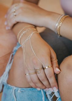 Channel your inner bohemian with this hand chain that loosely drapes around your finger and wrist. Whether you’re at a music festival or brunch with the girls, this hand candy turns any outfit into magic. 1.5mm Curb Chain. Bracelet is 6" with a 1" extender. S/M: ring size 5-7.5, wrist size 6-7" M/L: ring size 8-10.5, wrist size 7-7.5" Available in 14kt Gold Fill + Sterling Silver. Claire styles it on her left hand with our Flat Cigar Band, Confetti Ring, Josie Endless Bracelet, and F I N N Brace Confetti Ring, Magic Bracelet, M Ring, Hand Candy, Hand Chain, Curb Chain, 14kt Gold, Delicate Bracelet, Left Hand