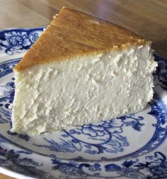 a piece of cheesecake on a blue and white plate