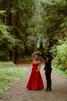 a man in a tuxedo and a woman in a red dress dancing