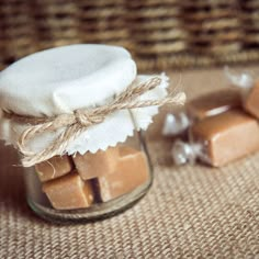 a jar filled with brown and white marshmallows on top of a table