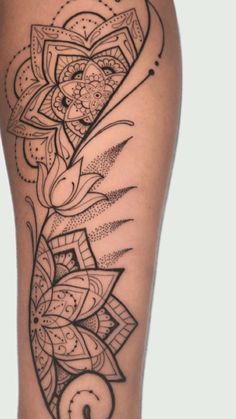 a woman's thigh with an intricate tattoo design on the side of her leg