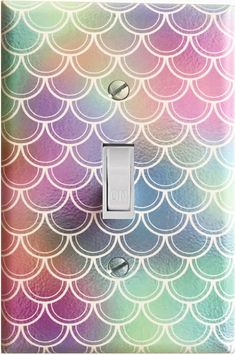 a light switch cover with an iridescent mermaid scale pattern on the front and sides