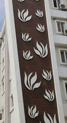 a tall building with white and brown designs on it's side