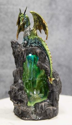 PRICES MAY VARY. This Armored Green Quartz Cave Climbing Dragon Backflow Incense Cones Burner With LED Light Statue stands at 11.25" tall, 5.5" long and 4.25" deep approximately. It weighs about 2.25" pounds. This Armored Green Quartz Cave Climbing Dragon Backflow Incense Cones Burner With LED light Statue is made of designer composite resin, hand painted and polished individually. Backflow incense cones are needed for this item and they are sold separately in our store in 4 different scents; Ro Cave Climbing, Armored Dragon, Emerald Dragon, Geode Cave, Maiden Mother Crone, Dragon Incense Burner, Dragon Light, Fairytale Decor, Backflow Incense Burner