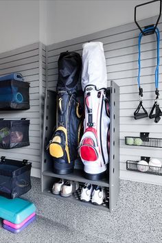 the inside of a garage with various sports equipment and storage bins on the wall