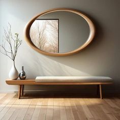 a wooden bench sitting in front of a round mirror on the side of a wall