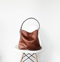 Medium/ large hobo style bag The bag is made of high quality faux vegan leather in distressed rich cognac brown color. (Also available in black- if you want the black version please leave a note on checkout) It is fully lined with cotton fabric in light brown color. * two inner slip pockets perfect for phone, keys, cardholder etc.  *closes with magnetic snap button (zipper option) *the shoulder strap and the crossbody strap (if added) are made of thick cowhide leather for extra support * additio Soft Leather Hobo Bag, Large Hobo Bag, Tooled Leather Bag, Everyday Purse, Brown Crossbody Bag, Hobo Style, Vegan Leather Bag, Brown Shoulder Bag, Brown Leather Bag