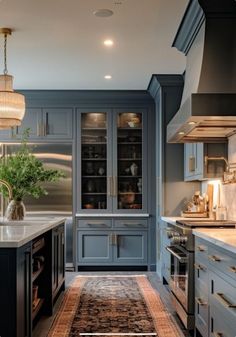 a kitchen with blue cabinets and an area rug