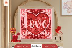 a valentine's day card with the word love cut out from paper and surrounded by other items