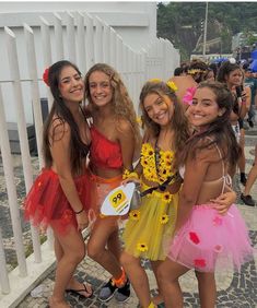 four girls dressed up in costumes posing for the camera