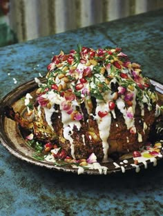 a plate filled with food on top of a blue countertop next to a knife and fork