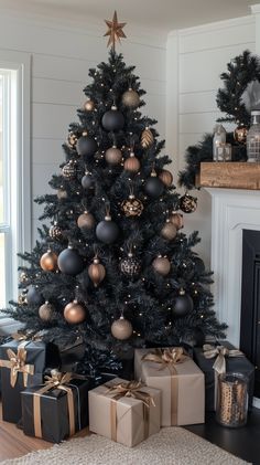 a black christmas tree with gold and silver ornaments