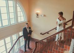 the bride and groom are walking down the stairs