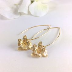 "Gold Orchid Flower Long Dangle Earrings, Floral Drop Earrings, Simple Earrings, Everyday Day Earrings, Wedding Bridal Earrings, Bridesmaid Earrings, Gift for Her Simply and dainty, these earrings are composed of a matte gold/rose gold plated orchid flower dangling from long gold/rose gold tone copper ear wires. Dangle length is 2\" (58mm) from top of ear wire. Flower measures 15x14mm Discount for multiple (3 pair or more) bridal party orders. CUSTOM REQUESTS ARE ALWAYS WELCOMED! ● Would you pre Gold Flower-shaped Hoop Earrings For Wedding, Dainty Gold Flower Earrings For Anniversary, Delicate Gold Hoop Earrings For Party, Dainty Gold Threader Earrings For Anniversary, Gold Flower Hoop Earrings For Wedding, Gold Floral Hoop Earrings For Wedding, Gold Hoop Earrings With Flower Charm For Wedding, Delicate Gold Flower Earrings For Anniversary, Delicate Gold Teardrop Flower Earrings