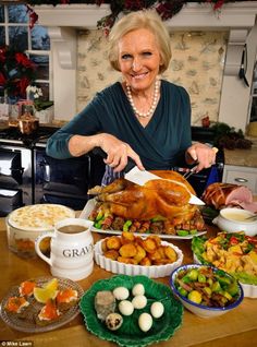 a woman is cutting a turkey on a table