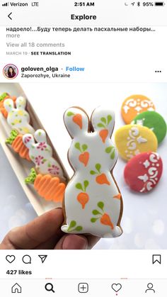 someone is holding some decorated cookies in their hand and looking at the photo on twitter