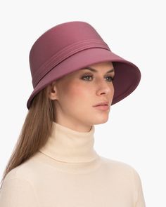 A fashionable women's cloche hat is hand-blocked of the finest superfelt, and then trimmed with a contrast stitch matching band of the same. The ultra sleek silhouette features a rakishly downturned brim, bringing focus to the eyes while framing the face beautifully. Brim span center front: 2.75"(7cm) side: 3"(7.5cm) Designed and finished in the USA Hand-blocked by skilled artisans Sustainable wool and cashmere blend superfelt Elasticized sweatband Adjustable head-size with hidden velcro® featur Formal Brimmed Fedora, Classic Wool Cloche Fedora, Fall Cloche Hat With Short Brim In Fur Felt, Fitted Hat With Short Brim And Lining, Fall Wide Brim Fur Felt Cloche Hat, Fur Felt Cloche Hat With Short Brim For Fall, Elegant Wool Felt Hat, Chic Brimmed Cloche Hat, Fitted Wool Cloche Hat