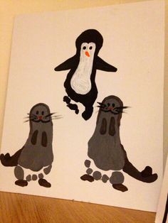 two penguins and a penguin on a white paper