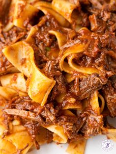 pasta with meat and sauce on a white plate