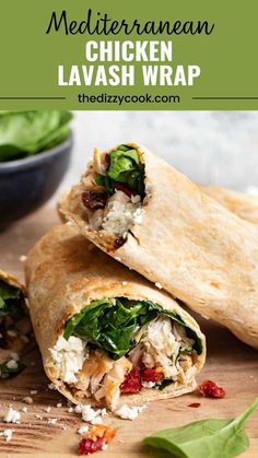 chicken and spinach wrap cut in half on a cutting board