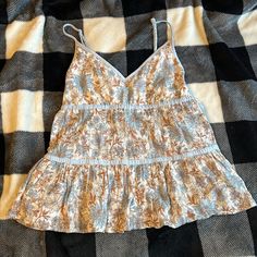 American Eagle Outfitters Tank Top Blouse. Size Xs. Beautiful Flowery Design, Has Great Movement. Very Pretty! Basically New Without Tags. Spring Brown Camisole, Brown Spring Camisole, Summer Brown Tops With Floral Print, Brown Cotton Tank Top For Day Out, Brown Cami Top For Spring, Casual Blue Spaghetti Strap Top, Brown Spaghetti Strap Tops For Spring, Bohemian Cotton Tops With Adjustable Straps, Spring Brown Spaghetti Strap Tops