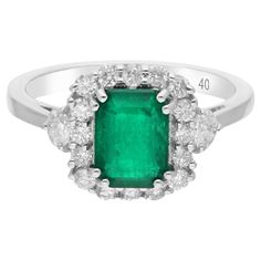 Immerse yourself in the luxurious splendor of this Real Zambian Emerald Gemstone Cocktail Ring, embellished with dazzling diamonds and meticulously crafted in opulent 18 karat white gold. This exquisite ring is a testament to refined elegance and timeless sophistication, boasting a total carat weight of 2.20. The ring is a size 7 US and may be resized to larger or smaller upon request. FOLLOW SPECTRUM JEWELS storefront to view the latest collection & exclusive pieces. Spectrum Jewels is proudly Formal Emerald Ring With Pave Diamond Setting, Formal Emerald Diamond Ring With Pave Setting, Fine Jewelry Diamond Cluster Gemstones, Exquisite Diamond Emerald Ring With Pave Setting, Classic Diamond Gemstone With Center Stone, Elegant Diamond Gemstones With Halo Setting, Elegant Cluster Diamond Emerald Ring, Elegant Cluster Emerald Diamond Ring, Elegant Emerald Cluster Ring With Diamonds