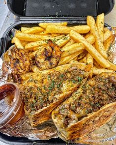 grilled steak and french fries in a plastic container