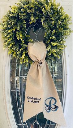 a wreath with a ribbon hanging on the front door to give it a special touch