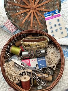 a basket filled with different types of thread and scissors