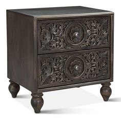 an ornate wooden cabinet with two drawers