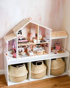 a doll house with furniture and accessories on display