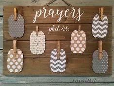 a wooden sign that has some tags hanging from it's sides and the words, prayer