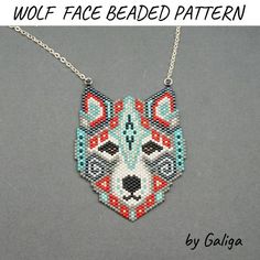 the wolf face beaded pattern is shown on a silver chain with an orange and blue design