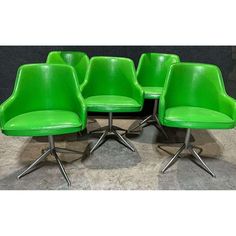 six green office chairs with chrome legs