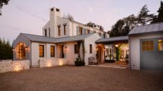 a large white house with lights on outside