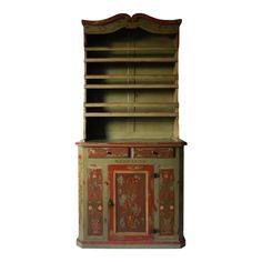 an old wooden cabinet with painted doors and drawers