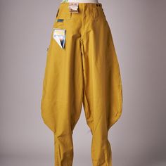 The Pants Are In Deadstock Condition, Still With Tags Attached. The Pants Are Mustard Yellow With Pin Stripe Lining. There Are A Ton Of Pockets As You Would Expect From Cargo Type Pants. There Is A Zipper At The Ankles To Tighten And Baggy Right About Where You Boot Will Sit. Closes With A Metal Ykk Zipper. Measures 36 Cm Across Waist, 30 Cm Rise, 84 Cm Inseam. Yellow Mens Fashion, High Waist Mustard Cotton Pants, Mustard Bottoms With Pockets For Workwear, Vintage Wide Leg Yellow Pants, Yellow Workwear Pants With Pockets, Mustard Trousers With Pockets, Retro Yellow Pants With Pockets, Yellow Baggy Trousers, Mustard High Waist Bottoms With Pockets