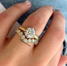 a woman's hand with two rings on it and the ring has three diamonds