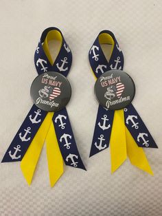 two navy and yellow ribbons with anchors on them, one is for the us navy