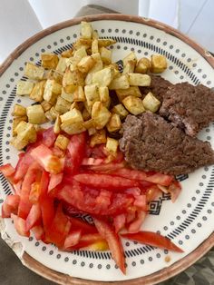 a white plate topped with meat and veggies