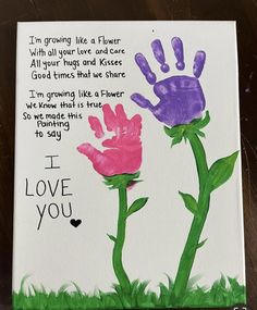 a handprinted card with two flowers and the words i love you