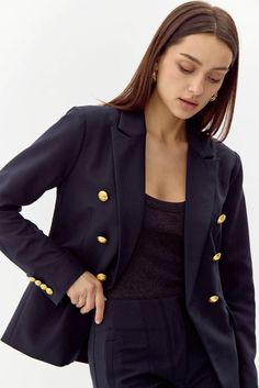 This bold blazer is adorned with gold buttons on the bodice and sleeves. The double-breasted structure also features faux, front pockets and a notched lapel. Can be matched with Colson Trousers. Blazer Double-Breasted Lined Length: 26" Chest: 17 1/4" Self: 77% Polyester, 16% Viscose, 7% Spandex Lining: 97% Polyester, 3% Spandex Hand wash in cold water with similar colors. Model is wearing a size small Style #: G247J1755 Office Peacoat With Lapel Collar And Button Closure, Office Peacoat With Button Closure And Lapel Collar, Business Blazer With Gold Buttons, Long Sleeve, Classic Office Blazer With Gold Buttons, Fitted Double-breasted Peacoat For Work, Tailored Blazer With Gold Buttons, Tailored Gold Blazer With Buttons, Tailored Blazer With Gold Buttons And Lapel Collar, Tailored Gold Blazer With Double Button Closure