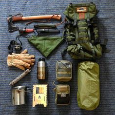 an assortment of camping gear laid out on the floor next to it's contents