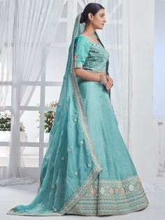 Introducing our precious sky-blue embroidered organza bridesmaid lehenga choli, a stunning ensemble that will make you stand out at any event or special occasion. This beautiful lehenga set features a sky-blue color organza lehenga with intricate multi-embroidered work and sequin detailing, paired with a matching choli and dupatta that also boasts beautiful embroidery and sequin work. The designer lace work on the dupatta adds an elegant touch to the overall look.
This lehenga choli set includes Embroidered Organza Gown For Navratri, Navratri Organza Embroidered Gown, Navratri Embroidered Organza Gown, Festive Light Blue Sharara For Reception, Light Blue Sets With Sheer Dupatta For Diwali, Organza Lehenga With Pallu For Reception, Reception Lehenga With Pallu In Organza, Blue Organza Sets With Dori Work, Blue Organza Sharara With Dori Work