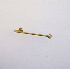 a close up of a door handle on a white wall with a gold colored finish