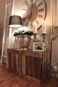 a living room filled with furniture and a large clock on the wall