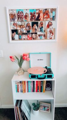 a record player sitting on top of a book shelf