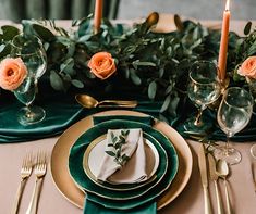 the table is set with gold and green place settings