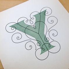 the letter y is made up of swirls and scrolls on white paper with black ink