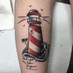 a small lighthouse tattoo on the leg